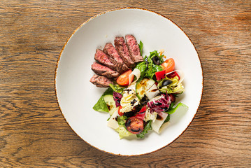 salad with beef on the wooden background