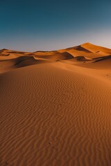 Vertical shot of a peaceful desert under the clear blue sky captured in Morocco © Andy Troy/Wirestock