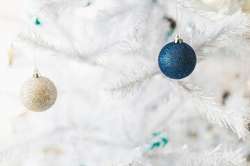 christmas tree with white frosted snow style and blue and silver toned baubles decoration