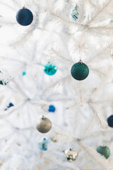 christmas tree with white frosted snow style and blue and silver toned baubles decoration