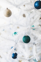 christmas tree with white frosted snow style and blue and silver toned baubles decoration