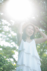 Naklejka premium Portrait of asian women enjoying freedom in city park morning sun light