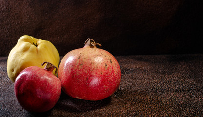Fruit quince and pomegranate on a light background there is a place for the inscription