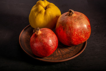 Fruit quince and pomegranate on a light background there is a place for the inscription
