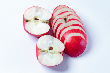 Red apples on a white plate, on a wooden, in a plate