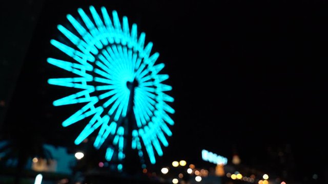 Blurred Ferris wheel near Mosaic shopping mall at Kobe city