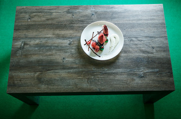 Fototapeta na wymiar top view on white restaurant plate with exclusive dessert