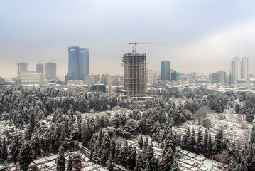 Istanbul, Turkey, 15 February 2012: Buildings of Zincirlikuyu and cemetery at snowy day.