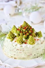 crep cake for Christmas and New Year.  Christmas tree decorations cabbage romanesco. Snack cake with salmon, avocado and soft cheese. Grains of cottage cheese play the role of snowdrifts.