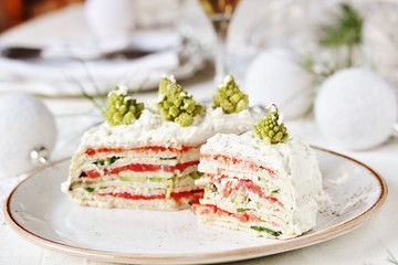 crep cake for Christmas and New Year.  Christmas tree decorations cabbage romanesco. Snack cake with salmon, avocado and soft cheese. Grains of cottage cheese play the role of snowdrifts.
