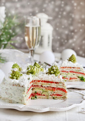crep cake for Christmas and New Year.  Christmas tree decorations cabbage romanesco. Snack cake with salmon, avocado and soft cheese. Grains of cottage cheese play the role of snowdrifts.