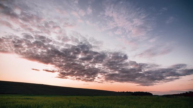 Spectacular clouds movement time lapse video at sunset time in the fields.