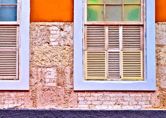 Two classic windows in a colorful villa during a complete home restoration project.