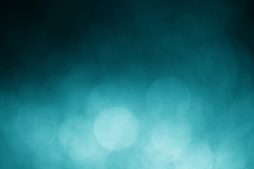 Green light bokeh on a black background, abstract
