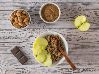Quinoa porridge with Apple and almond milk on a wooden table. Flat lay.