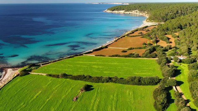 Drone flying and filming over Binigaus beach landscape in Menorca Island, Spain