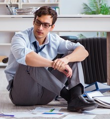 Bankrupt businessman angry in the office floor