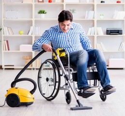 Fototapeta na wymiar Disabled man cleaning home with vacuum cleaner