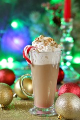 Original New Year's coffee with whipped cream is decorated with food confectionery gold balls and food glitters. original decoration idea with food gold. festive mood.