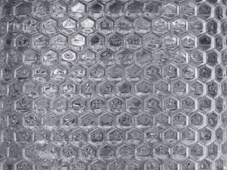 hexagon shape of transparent glass wall background with water drops.