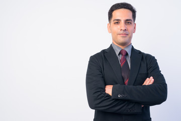 Portrait of handsome Persian businessman in suit with arms crossed