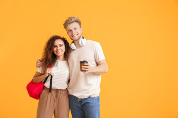 Portrait of female and male students on color background