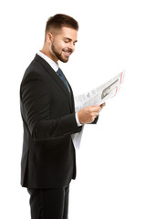 Handsome businessman with newspaper on white background