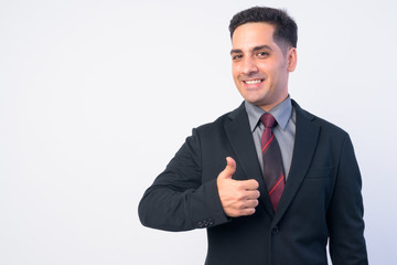 Portrait of happy Persian businessman in suit giving thumbs up