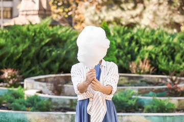 Woman with sweet cotton candy outdoors