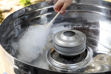 Making of sweet cotton candy outdoors, closeup
