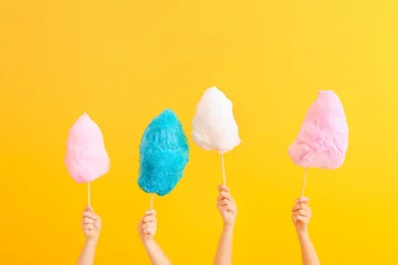  Female hands with different cotton candy on color background © Pixel-Shot