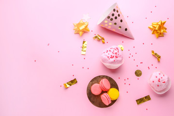 Tasty cotton candy with macarons and party decor on color background