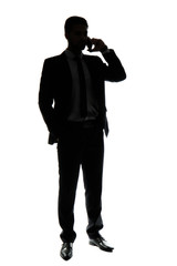 Silhouette of handsome businessman talking by phone on white background