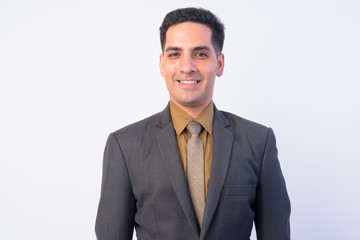 Face of happy handsome Persian businessman in suit smiling