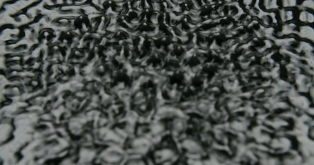 Quicksilver vibrating with different cymatic patterns and waves. Static shot with soft commercial backlight.