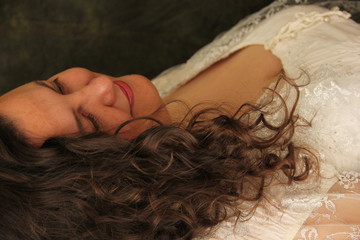 Portrait of a full happy woman in a white dress. plus size model