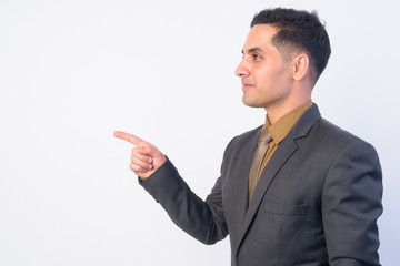 Profile view of handsome Persian businessman in suit pointing finger