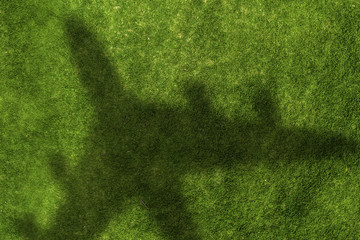 Airplane shadow on green field