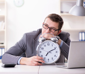 Businessman employee in urgency and deadline concept with alarm