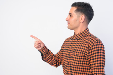Profile view of handsome Persian hipster man pointing finger