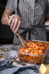 Homemade delicious baked cheese pie with vegetables. Vertical shot. Close-up