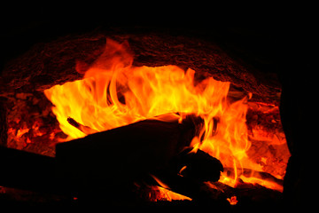 fire burning charcoal in the dark background.