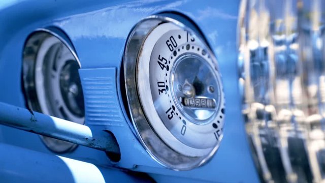 Close up Speedometer, dashboard. Action. Dashboard of a blue vintage American car