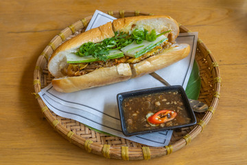 Delicious Vietnamese banh mi on traditional rattan tray in restaurant