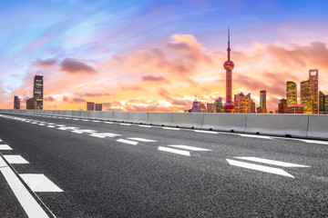 Fototapeta na wymiar Sunset architectural landscape and asphalt road in Shanghai