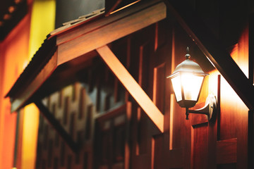 Wall lamp, old wooden house