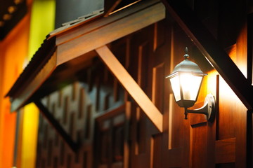 Wall lamp, old wooden house