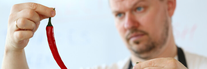 Professional Chef Showing Yellow Chili Pepper
