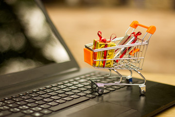 Red heart in a trolley on a laptop keyboard. Ideas about online shopping, online shopping is a form...