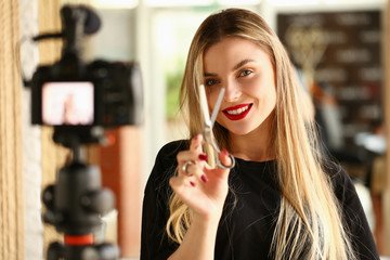 Female millennial vlogger hold in hand